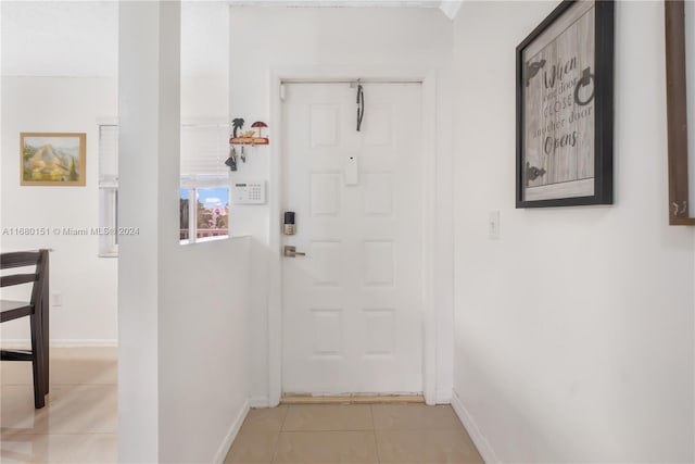 entryway with light tile patterned flooring