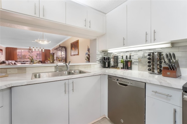 kitchen featuring white cabinetry, crown molding, dishwasher, and sink