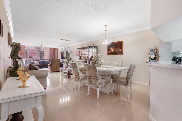 tiled dining room featuring ornamental molding, a textured ceiling, and ceiling fan