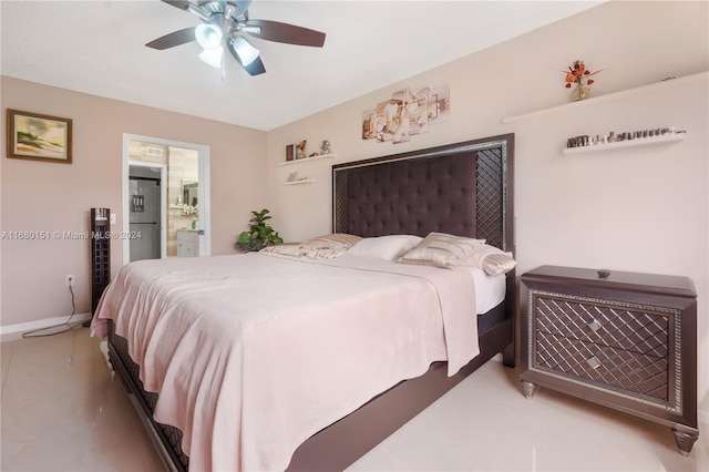 bedroom with stainless steel fridge with ice dispenser, ensuite bathroom, and ceiling fan