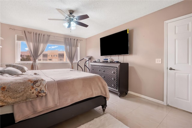 bedroom featuring light tile patterned flooring, a textured ceiling, and ceiling fan