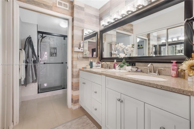 bathroom featuring vanity, walk in shower, and tile patterned flooring