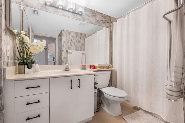 bathroom featuring vanity, toilet, tile patterned floors, and a shower with curtain