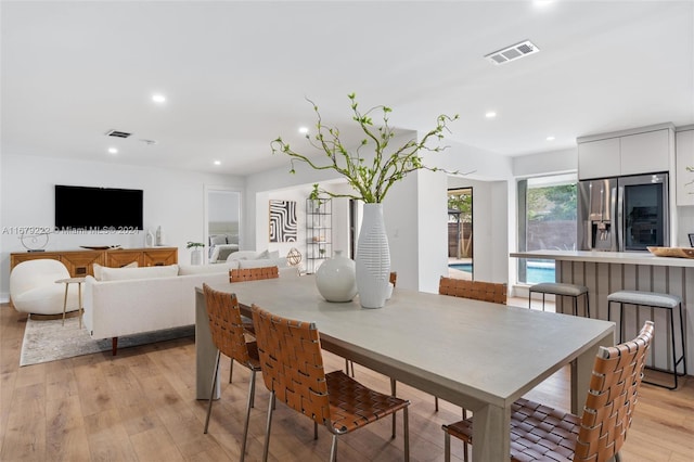 dining space featuring light wood-type flooring