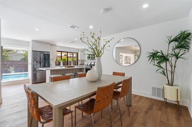 dining room with light hardwood / wood-style floors and plenty of natural light