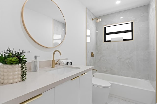 full bathroom with tiled shower / bath, vanity, and toilet