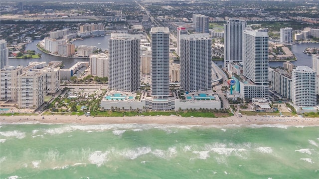 aerial view featuring a water view and a beach view