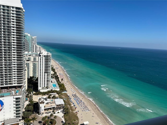 drone / aerial view featuring a water view and a beach view