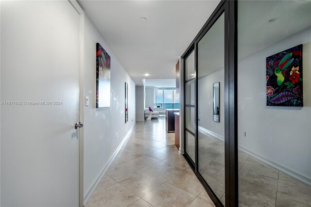 hall featuring light tile patterned flooring