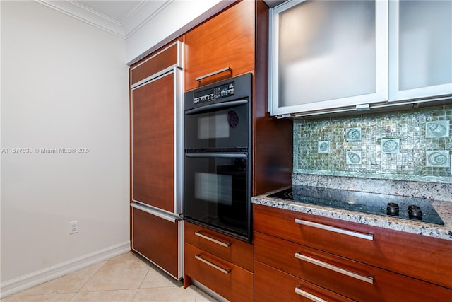 kitchen featuring decorative backsplash, light tile patterned floors, ornamental molding, black appliances, and light stone counters