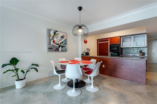 dining area with ornamental molding and light tile patterned floors