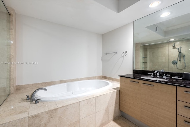 bathroom featuring vanity, shower with separate bathtub, and tile patterned floors