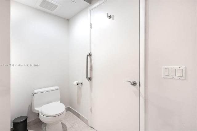 bathroom featuring toilet and tile patterned flooring