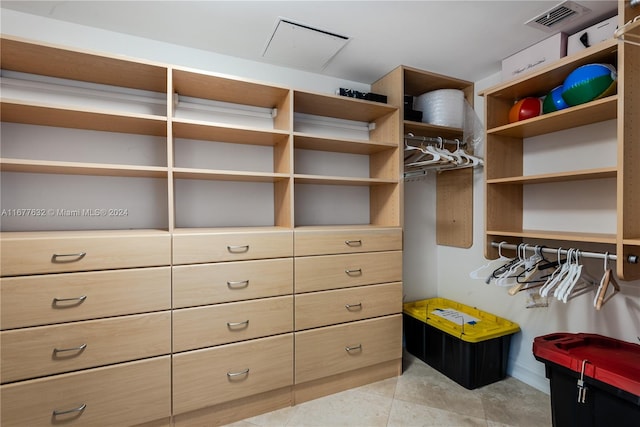 spacious closet with light tile patterned floors