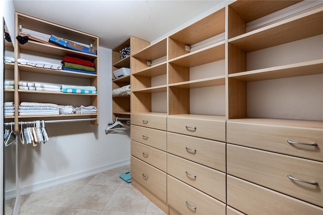 walk in closet featuring light tile patterned flooring