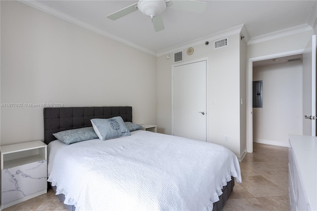 tiled bedroom featuring a closet, ceiling fan, and crown molding