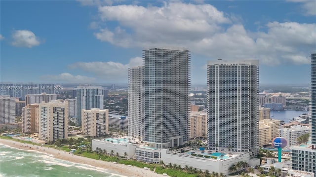 property's view of city featuring a water view and a beach view