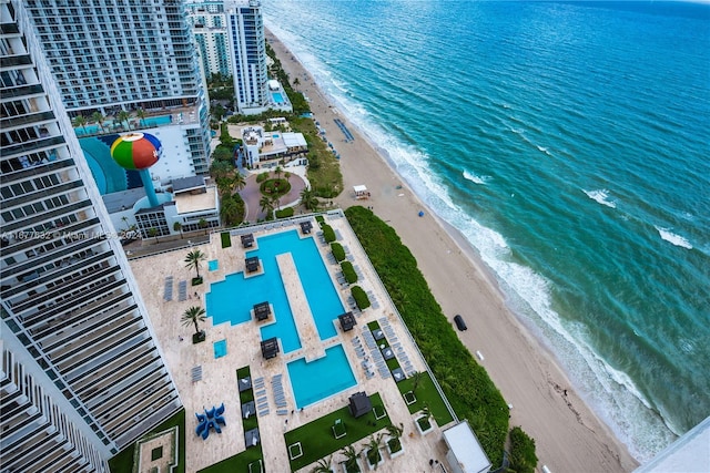 drone / aerial view featuring a view of the beach and a water view