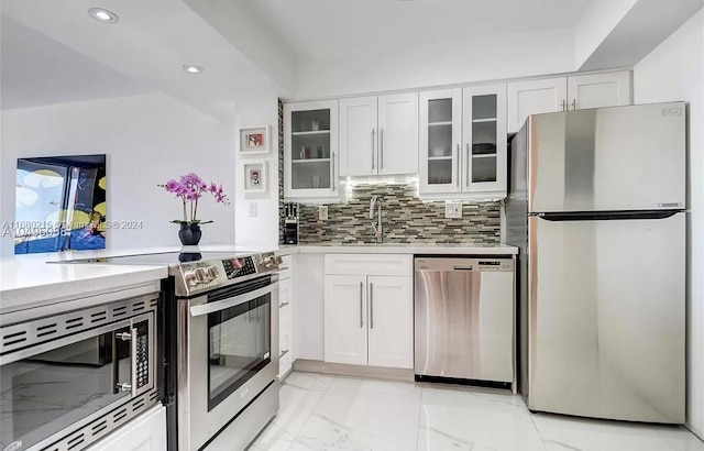 kitchen with sink, appliances with stainless steel finishes, and white cabinetry