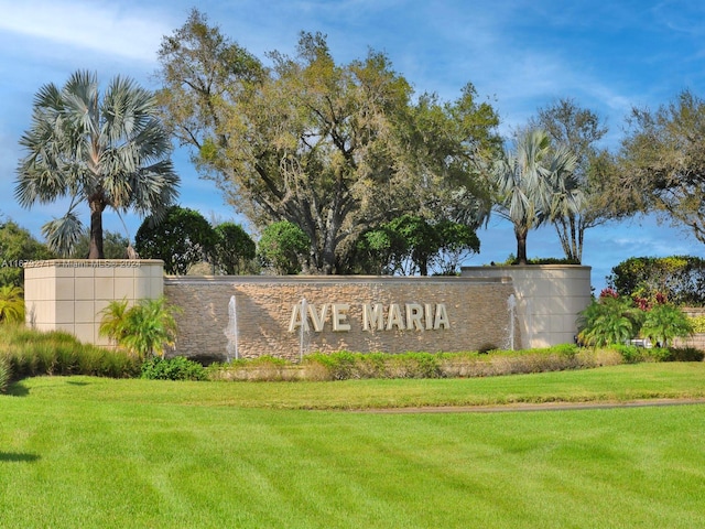 community / neighborhood sign with a lawn