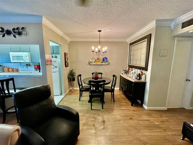 dining space with crown molding, light hardwood / wood-style flooring, and a textured ceiling