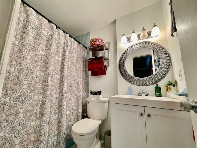 bathroom featuring vanity, toilet, and a shower with curtain