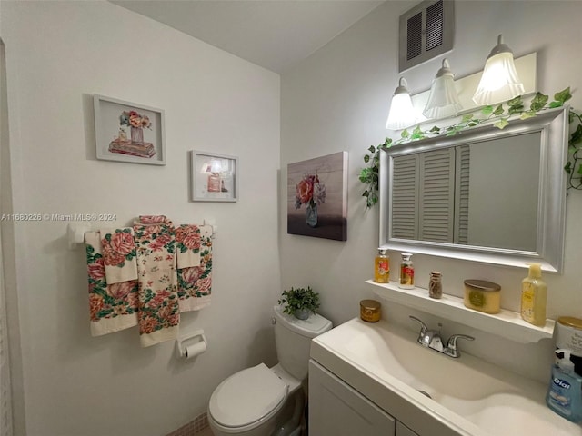 bathroom featuring toilet and vanity