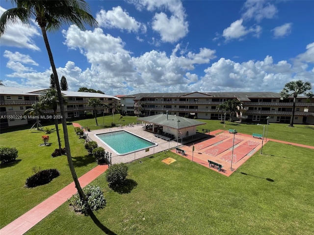 view of swimming pool with a yard and a patio