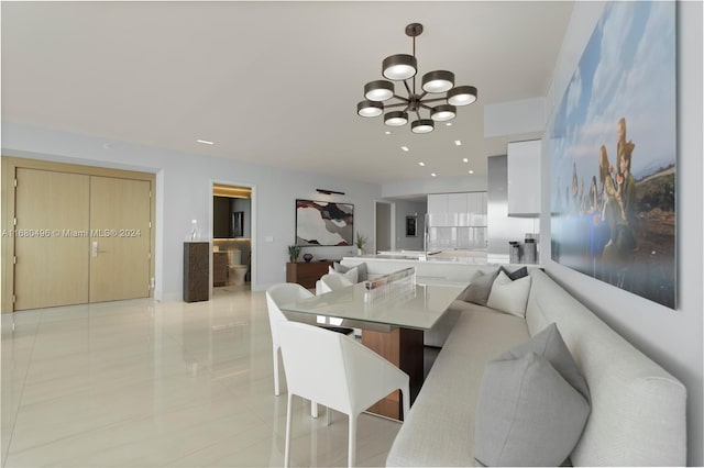 tiled dining room with a notable chandelier