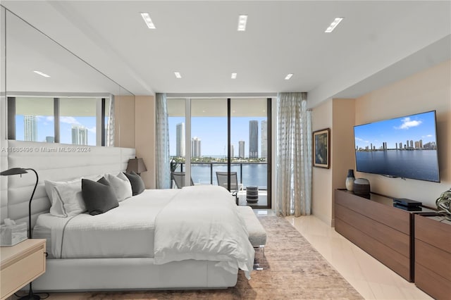 tiled bedroom featuring floor to ceiling windows and access to outside