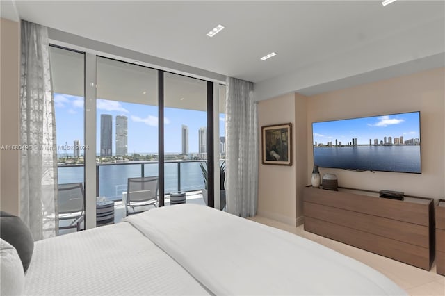 bedroom with access to exterior and a water view