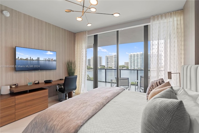 bedroom with access to outside, floor to ceiling windows, built in desk, and a chandelier