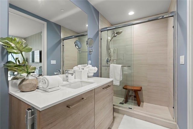 bathroom featuring vanity and an enclosed shower