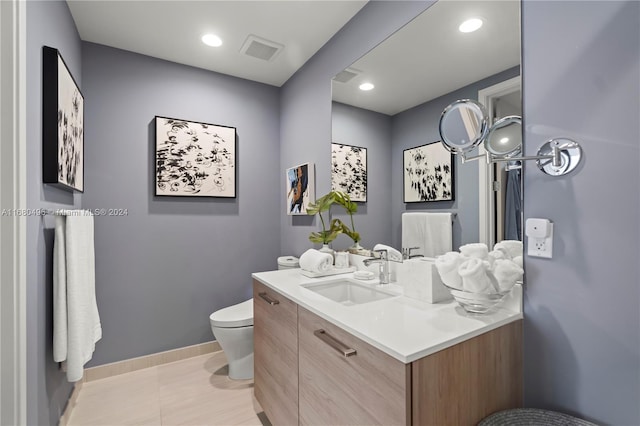 bathroom with tile patterned floors, vanity, and toilet