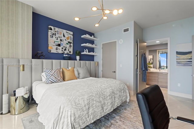 bedroom featuring tile patterned floors, ensuite bathroom, and an inviting chandelier