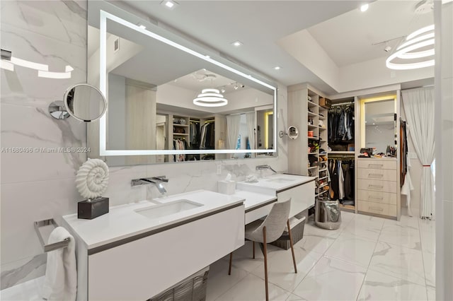 bathroom with vanity, a raised ceiling, and backsplash