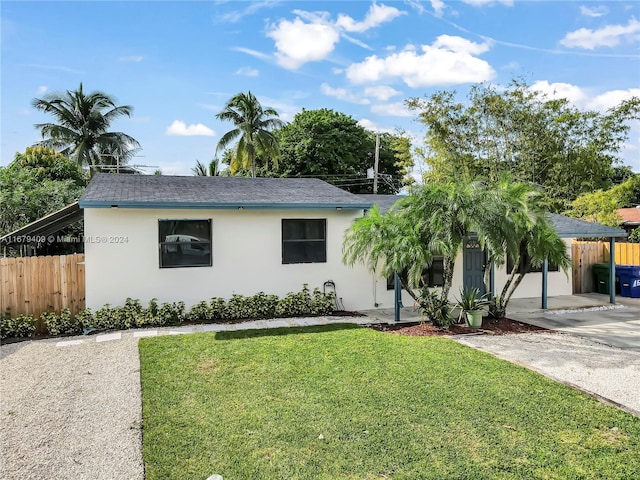 ranch-style home featuring a front yard