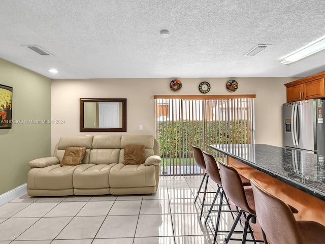 tiled living room with a textured ceiling