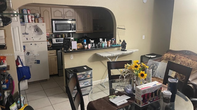 kitchen featuring stainless steel appliances and light tile patterned floors