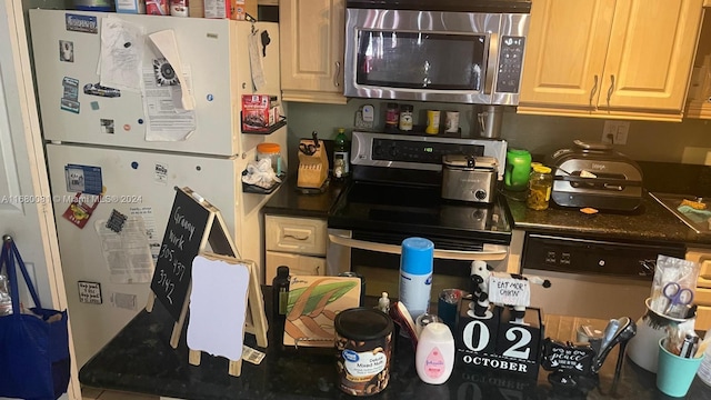 kitchen featuring white fridge and black range with electric stovetop