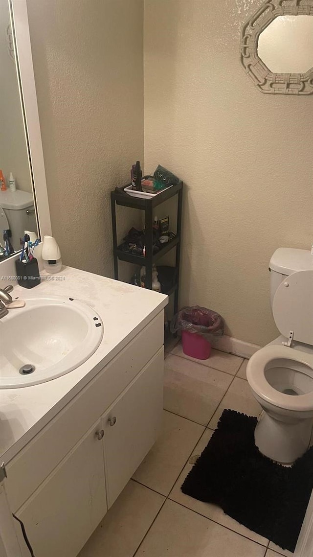 bathroom featuring vanity, toilet, and tile patterned floors