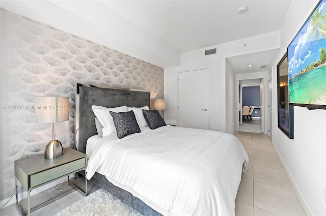 401 N Birch Rd Unit 505, Fort Lauderdale, FL 33304 - bedroom with tile patterned floors, baseboards, and an accent wall