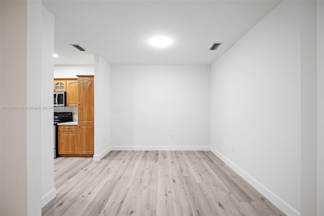 spare room with light hardwood / wood-style flooring