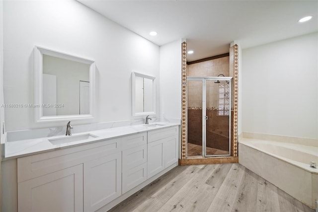 bathroom featuring vanity, independent shower and bath, and wood-type flooring