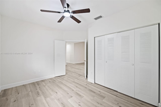 unfurnished bedroom with a closet, light wood-type flooring, and ceiling fan