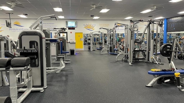 workout area with a drop ceiling and ceiling fan