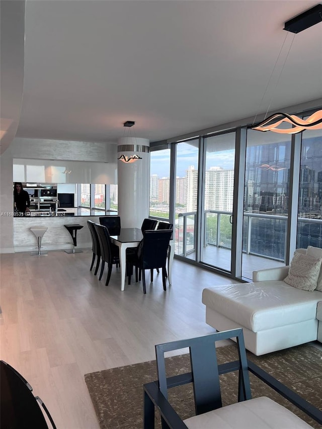 dining area with hardwood / wood-style flooring and floor to ceiling windows