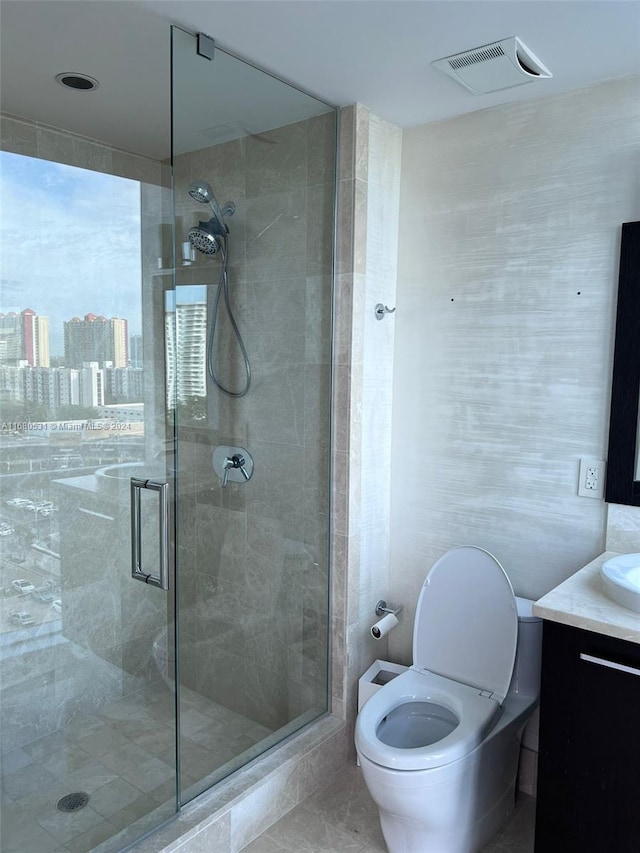 bathroom featuring vanity, an enclosed shower, and toilet