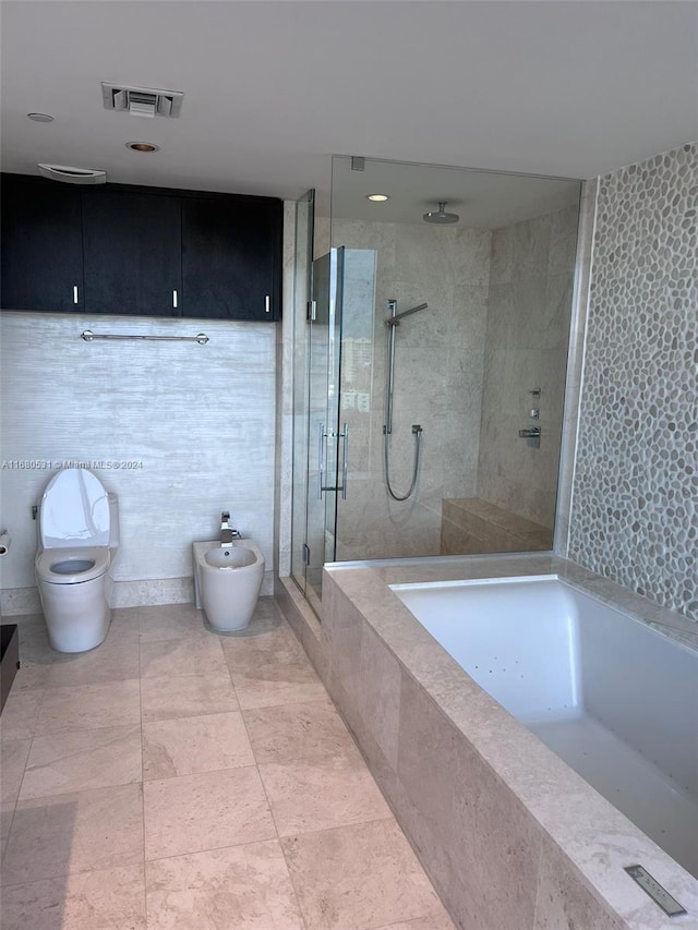 bathroom featuring toilet, a bidet, and shower with separate bathtub