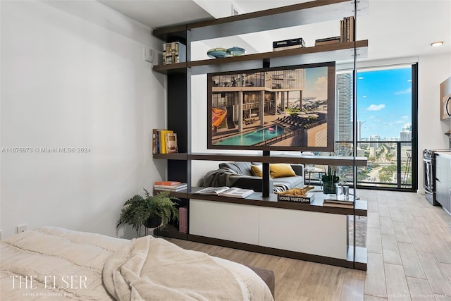 bedroom featuring light hardwood / wood-style floors and a wall of windows